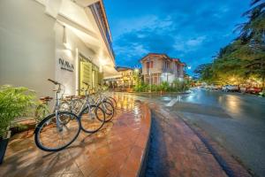 a group of bikes parked next to a building at Nava Luang Prabang Hotel in Luang Prabang