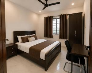 a bedroom with a bed and a desk and a bed sidx sidx sidx at Mahankali Guest House in Hyderabad