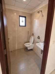 a bathroom with a toilet and a sink at Mahankali Guest House in Hyderabad