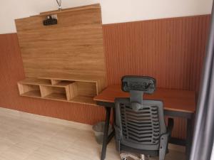 a room with a wooden table and a stove at AA Guest House Padonan in Dalung