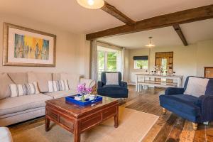 a living room with a couch and chairs and a table at Drift Cottage, Rendlesham in Rendlesham