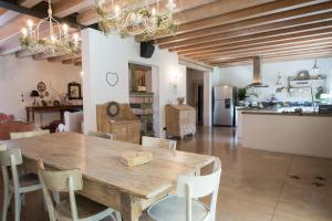 a kitchen and dining room with a wooden table and chairs at B&B Maison Parco Del Brenta in Curtarolo +65 photos