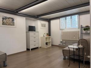 a room with a bed and a dresser with a television at Ai Foggiali in Matera