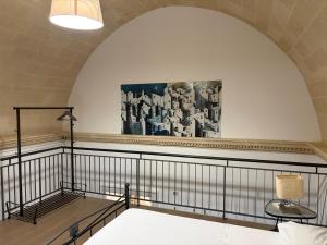 a room with a bed and a painting on the wall at Ai Foggiali in Matera