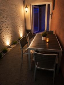 a wooden table and chairs on a patio at night at Wohnliches Apartment in Koblenz-Bubenheim in Koblenz
