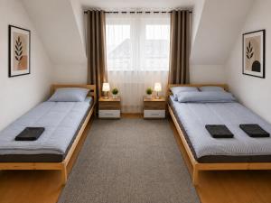 a bedroom with two beds and a window at Wohnliches Apartment in Koblenz-Bubenheim in Koblenz