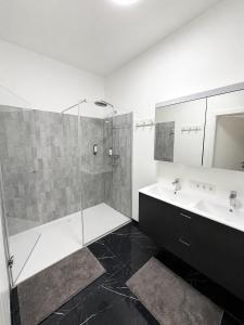 a bathroom with a shower and a sink at Maria Blick in Maria Wörth +14 photos