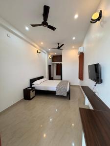 a bedroom with a bed and a flat screen tv at Ocean Kala Crest in Cheyūr