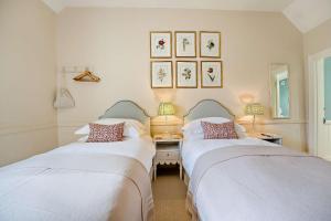 two beds in a room with a desk and two lamps at Tiger Inn - Grace in Eastbourne