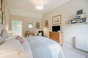 a bedroom with a bed and a television in it at Tiger Inn - Grace in Eastbourne