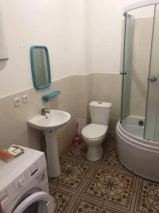a bathroom with a toilet and a sink and a shower at Море і Сосни in Koblevo