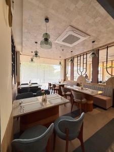 a restaurant with couches and tables and chairs at Hotel Cloud by ARIENA in Phundardih