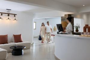 a group of people walking through a living room at Domotel Kea in Koundouros +58 photos