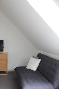 a living room with a couch and a television at Neeme Marina Questhouse in Neeme