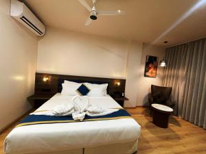 a bedroom with a bed with a heart decoration on it at Hotel Cloud by ARIENA in Phundardih