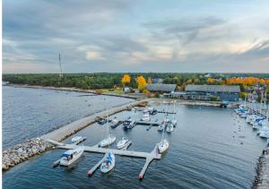 a group of boats docked at a dock in the water at Neeme Marina Questhouse in Neeme