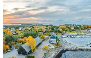 an aerial view of a marina with a barn and a lake at Neeme Marina Questhouse in Neeme +3 photos