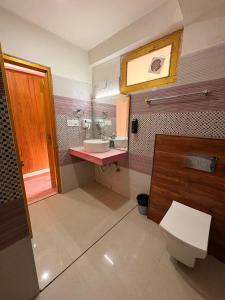 a bathroom with a sink and a toilet at Hotel Naina Rockland , Manali in Vashisht