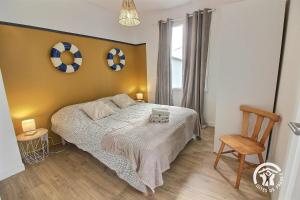 a bedroom with a bed with two soccer balls on the wall at Le sémaphore in Saint-Cast-le-Guildo