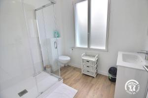 a bathroom with a shower and a toilet and a sink at Le sémaphore in Saint-Cast-le-Guildo +13 photos