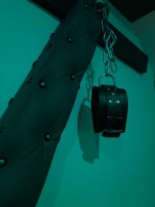 a black jacket with a camera on a chain at Hédoné LoveRooms in La Chapelle +63 photos