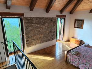 a room with a stone wall in a house at Cristallo del Gran Sasso in Forca di Valle