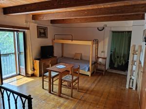 a room with a bed and a table and a desk at Cristallo del Gran Sasso in Forca di Valle