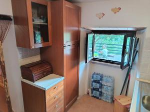 a kitchen with a refrigerator and a window at Cristallo del Gran Sasso in Forca di Valle