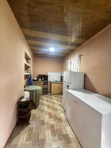 a kitchen with a refrigerator and a couch in a room at Barisakho Mountain House in Chirdili