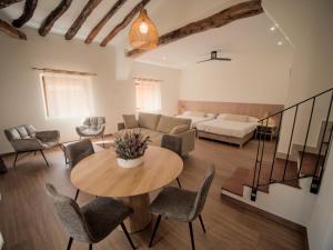 a living room with a table and chairs and a couch at El Passeig Rural in Castalla