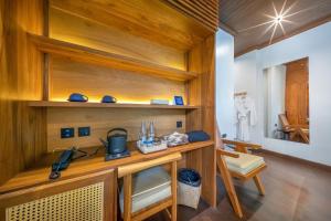 a room with a wooden desk and a sink at Nava Luang Prabang Hotel in Luang Prabang +133 photos
