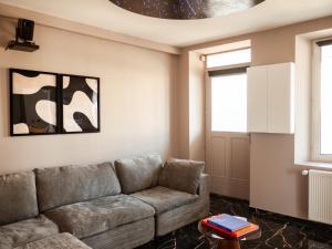 a living room with a couch and a table at Galaxy Mood - 10 min Disney in Couilly-Pont-aux-Dames
