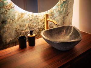 a bathroom with a bowl sink and two bottles of soap at Galaxy Mood - 10 min Disney in Couilly-Pont-aux-Dames