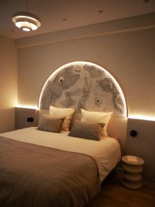 a bedroom with a large bed with a large wall at Galaxy Mood - 10 min Disney in Couilly-Pont-aux-Dames +19 photos