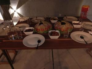 a table with plates and bowls of food on it at Rainforest White House in Deniyaya