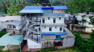an overhead view of a house with a fire escape at Rainforest White House in Deniyaya