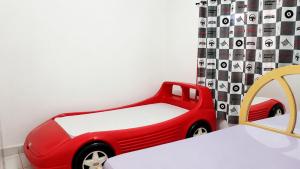 a toy car next to a bed in a room at Estação lazer e Eventos in Mairinque +14 photos