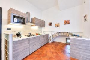 a kitchen with a sink and a counter at Aparthotel Arona in Arona
