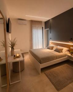 a bedroom with a large bed and a table at Altea in Taurianova