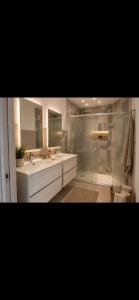 a bathroom with two sinks and a shower at Altea in Taurianova