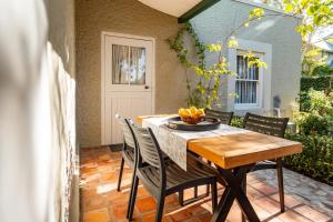 a wooden table and chairs on a patio at Elizabeth's Cottage in Montagu +25 photos
