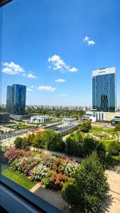 a view from a window of a city with buildings at NestOne Apartment 39th floor in Tashkent