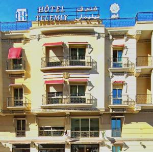 a building with balconies and a sign on it at Hôtel Telemly - Chaine El Djazair in Alger