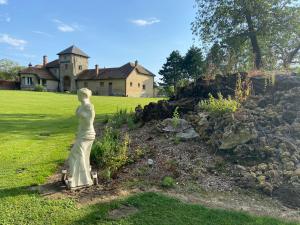 a statue of a woman in front of a house at Lys in Gury