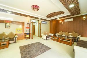a living room with couches and a table at FabHotel Aayansh in Jaipur +29 photos