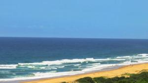 a group of people on a beach near the ocean at #7 Illovo Views in Kingsborough +16 photos