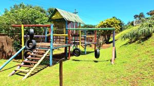 a playground with two swings and a slide at #7 Illovo Views in Kingsborough