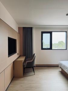a hotel room with a bed and a desk and a television at Hotel Nueva Europa Valencia in Valencia