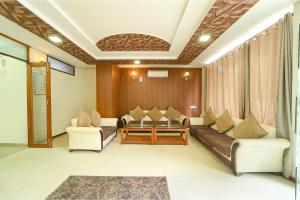 a living room with couches and a table at FabHotel Aayansh in Jaipur