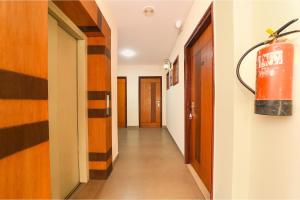 a hallway with a fire extinguisher on the wall at FabHotel Aayansh in Jaipur